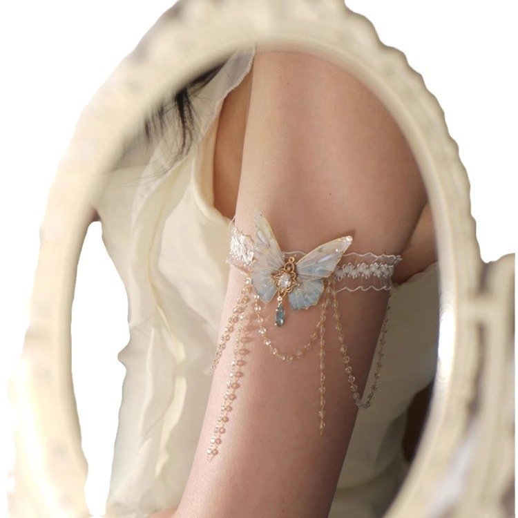 A delicate lace body chain with butterfly charms and tassels, styled on an arm 5