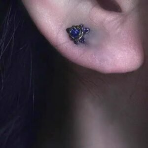 Purple iris pendant earrings on a model showing minimalist design