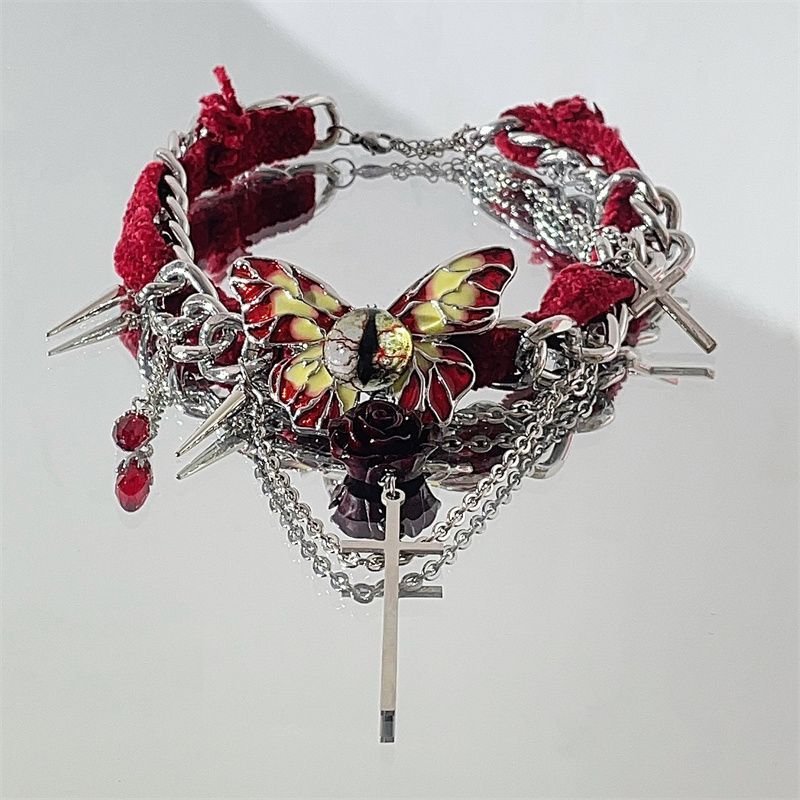 Gothic red velvet butterfly choker necklace with red velvet ribbon and silver butterfly pendant on a model's neck 3