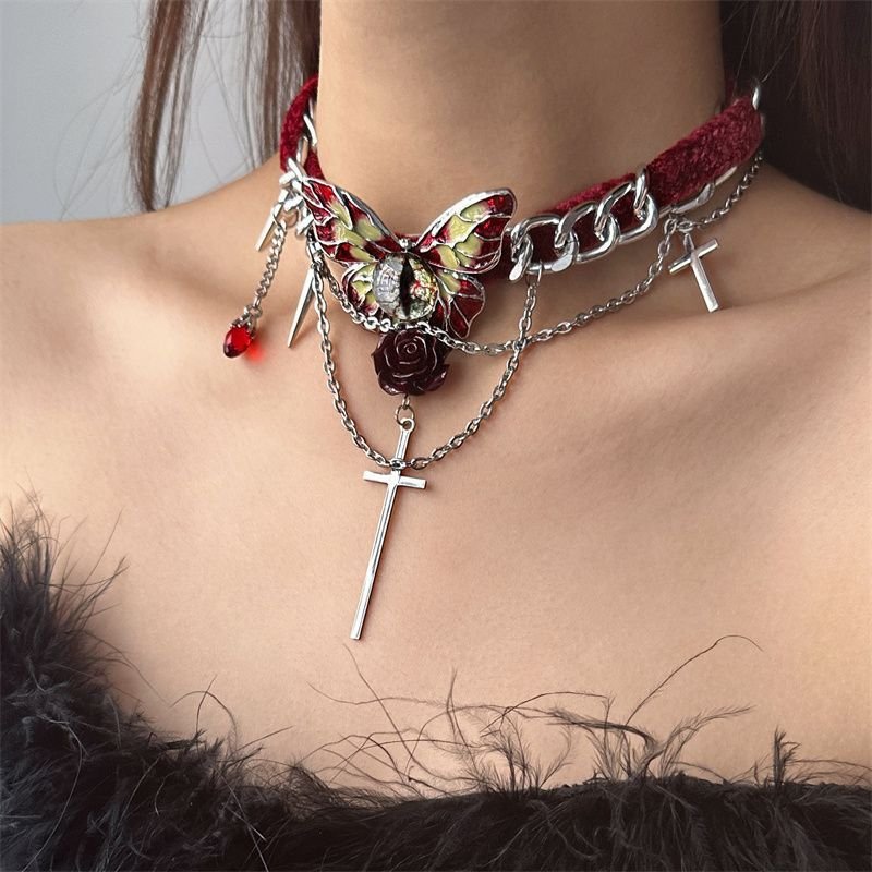 Gothic red velvet butterfly choker necklace with red velvet ribbon and silver butterfly pendant on a model's neck