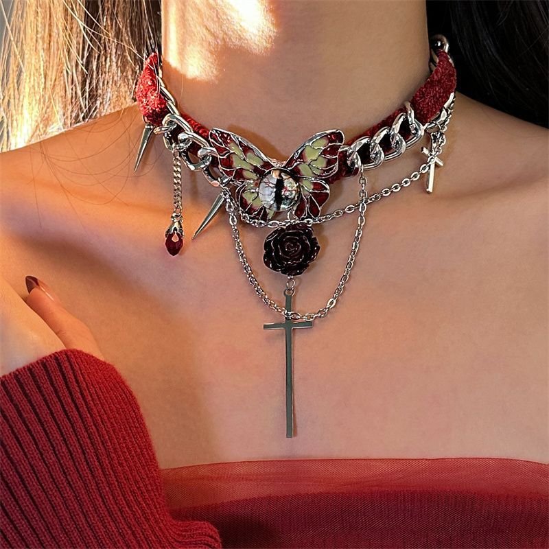 Gothic red velvet butterfly choker necklace with red velvet ribbon and silver butterfly pendant on a model's neck 2